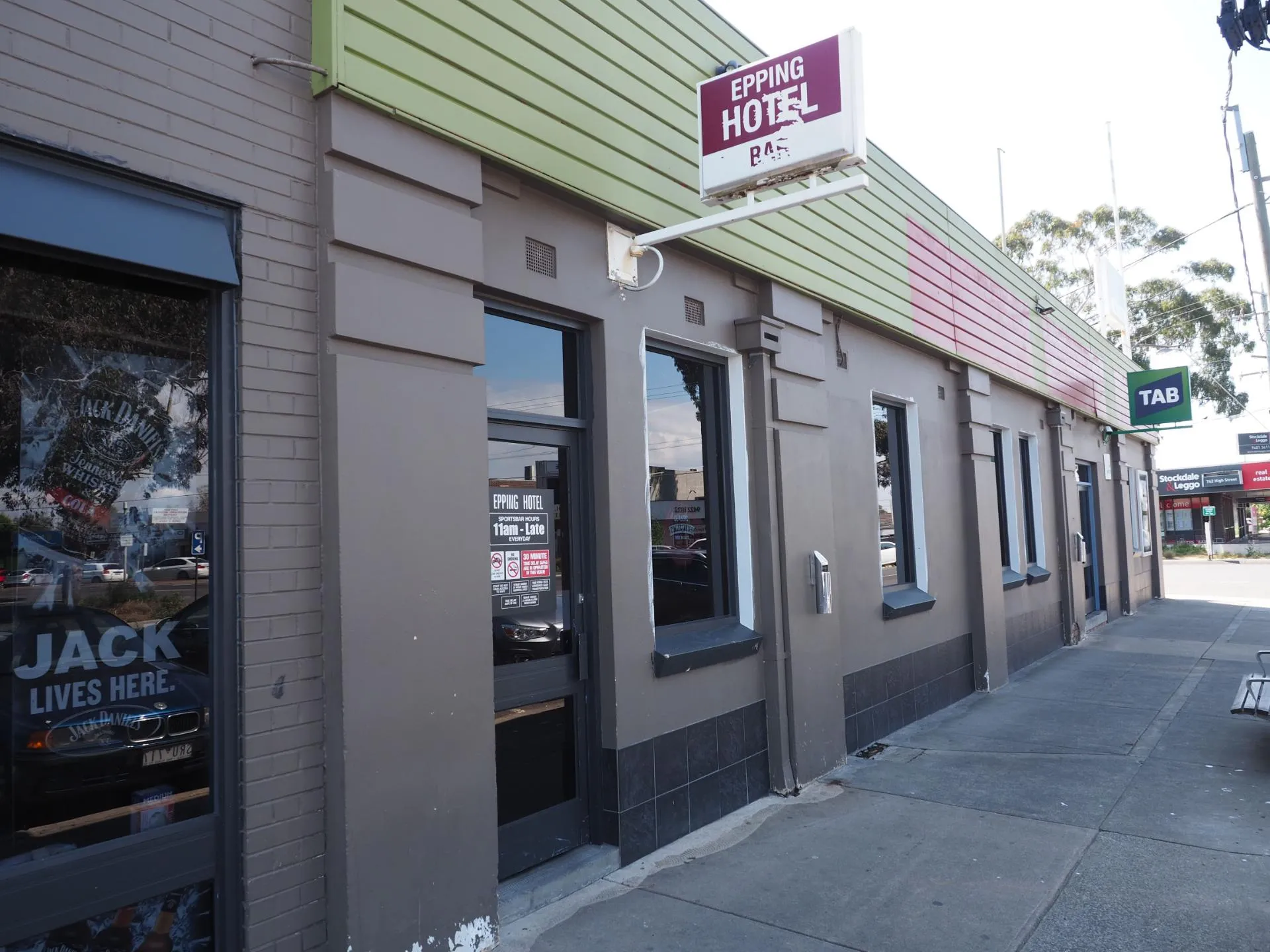 Exterior of a Melbourne hotel and gaming venue, repainted in charcoal, grey and sage