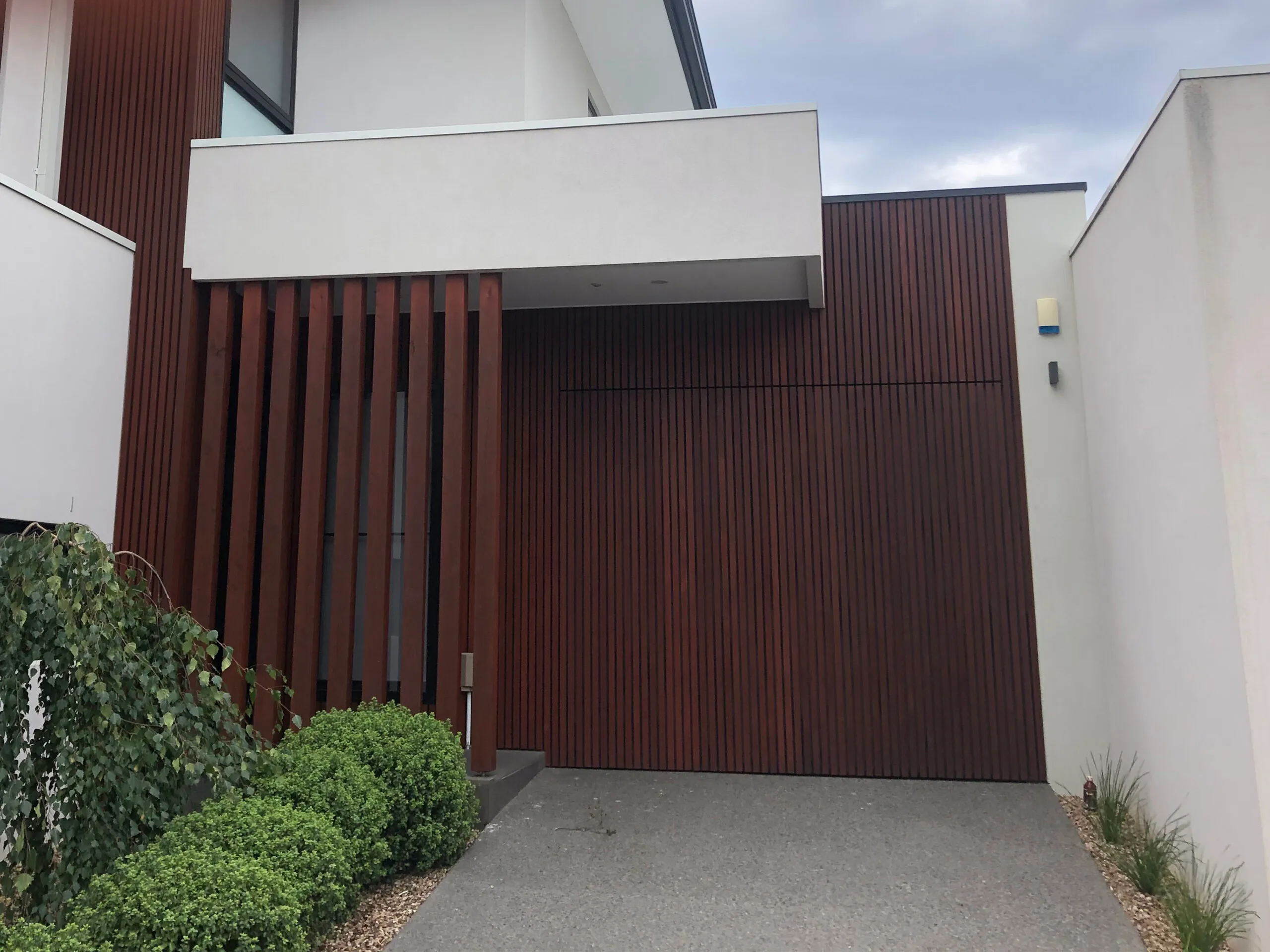 Close view of richly stained vertical timber battens and screening on a modern Melbourne home entrance